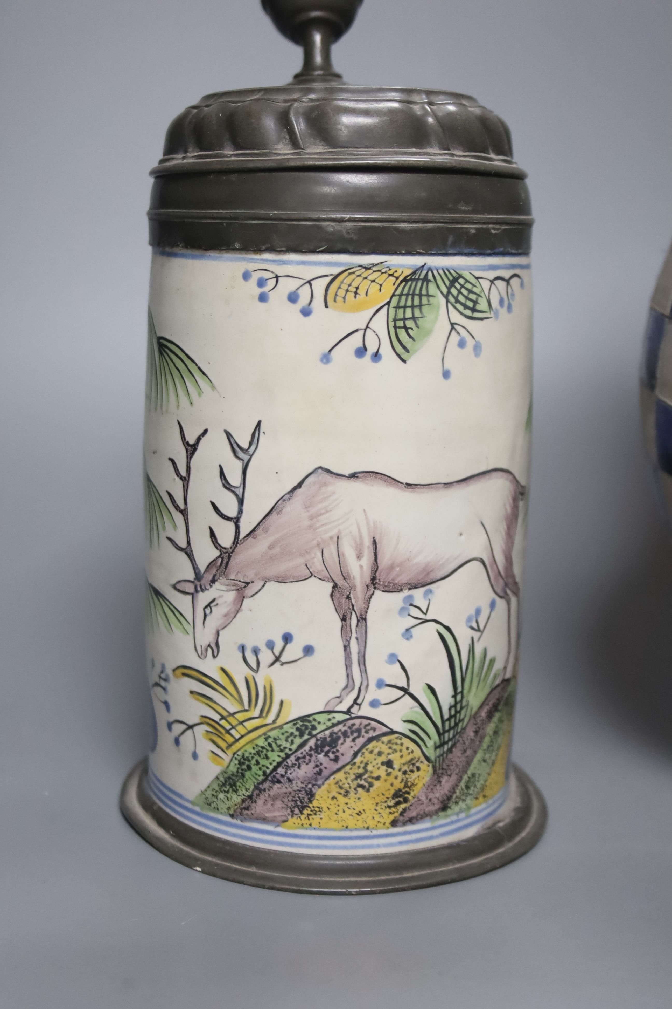 An 18th/19th century German faience pewter-mounted stein decorated with a stag and a German stoneware pitcher, height 25cm & 30cm
